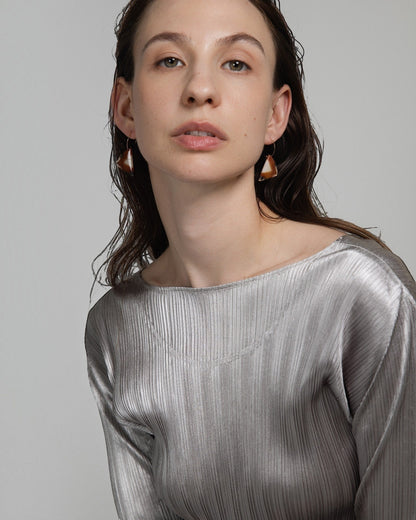 Elsita Jewelry Wild 13 raw Indonesian agate slice earrings on 14K gold-filled hoops worn by a model in a silver top.