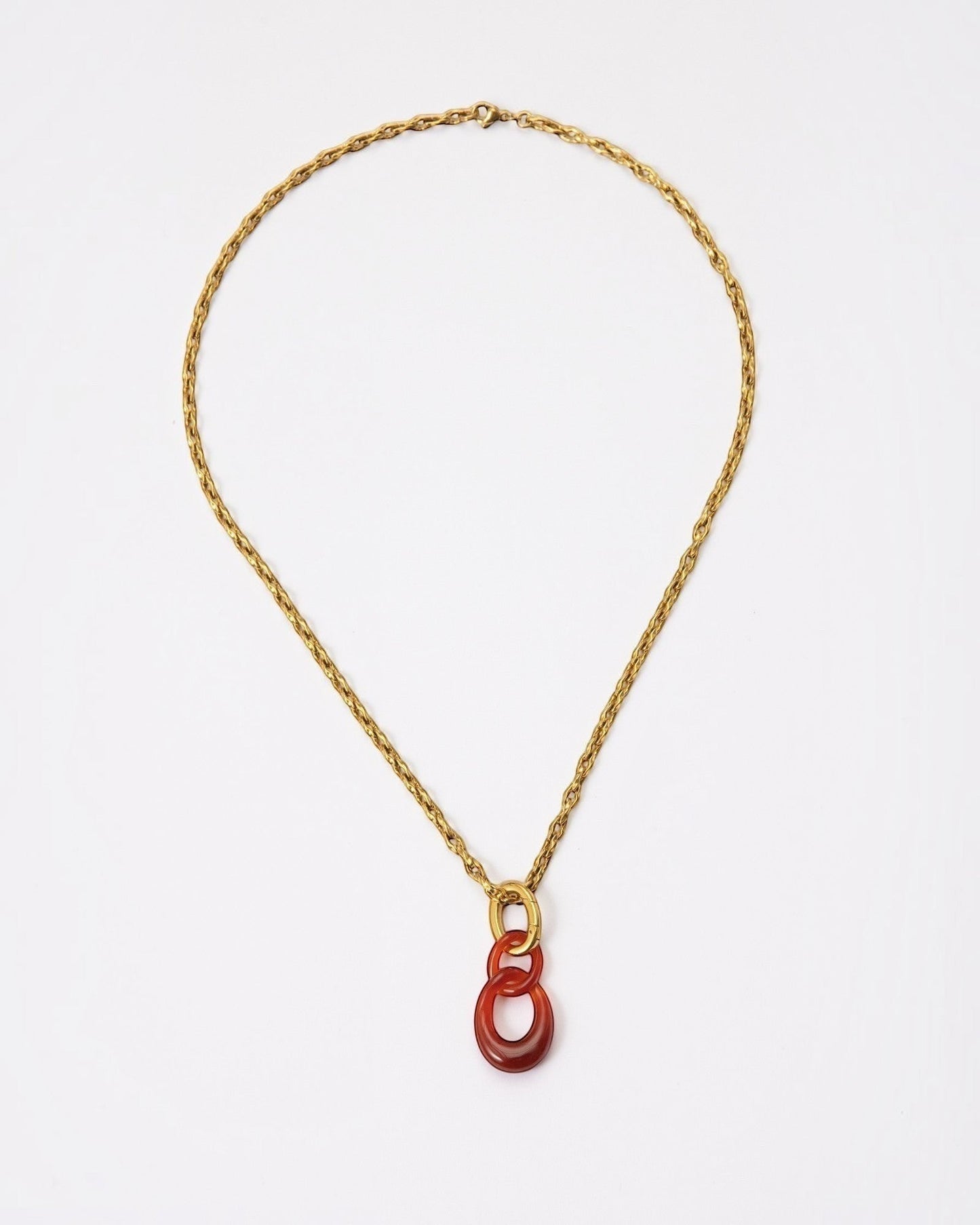 Elsita Jewelry Link Red necklace featuring hand-carved red agate interlocked chain pendant on a gold-tone metal chain.