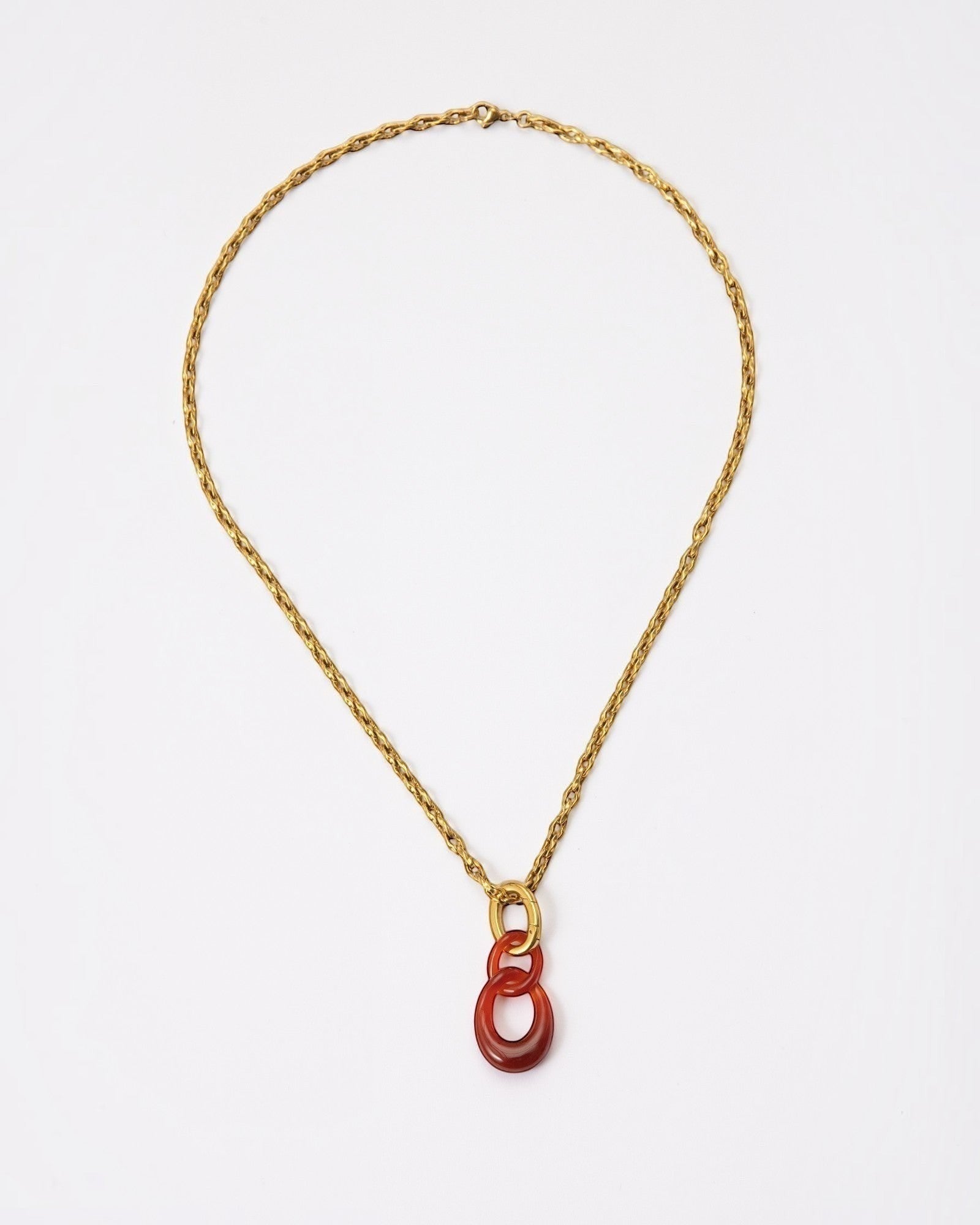 Elsita Jewelry Link Red necklace featuring hand-carved red agate interlocked chain pendant on a gold-tone metal chain.