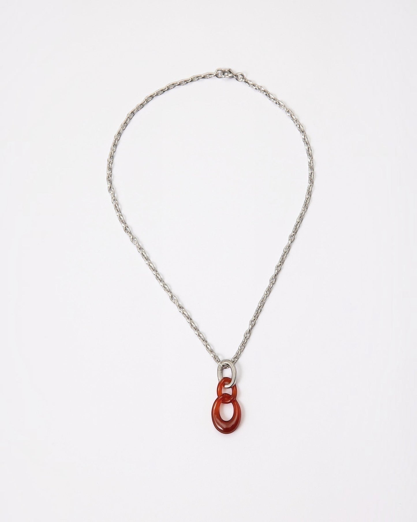 Elsita Jewelry Link Red necklace featuring a hand-carved red agate interlocked chain pendant on a silver-tone chain.