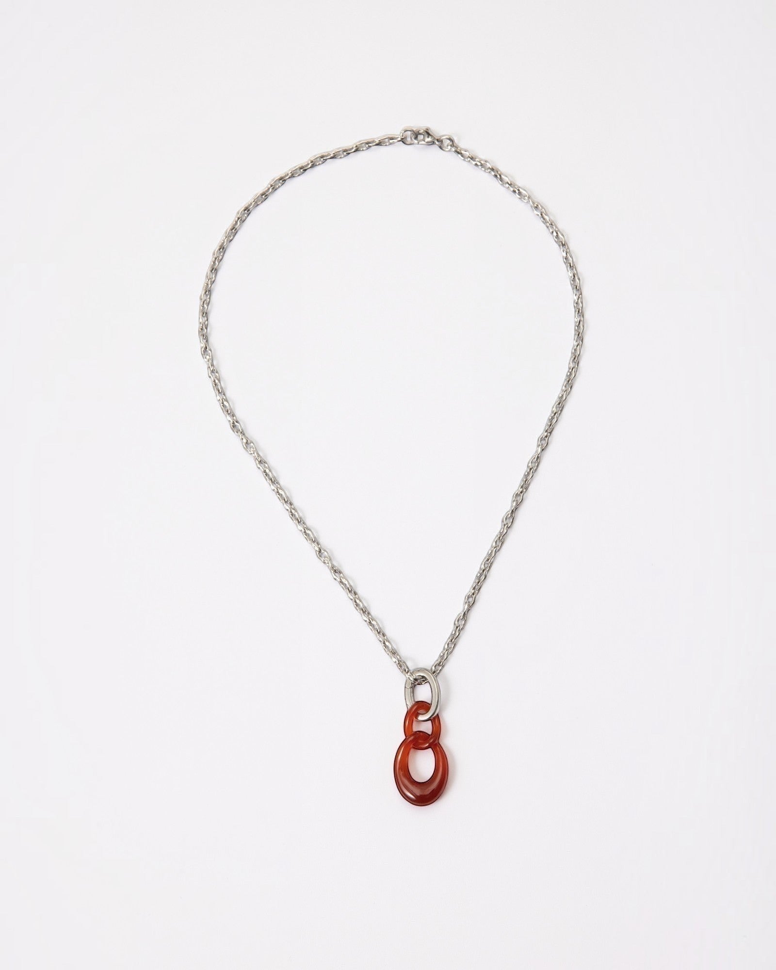 Elsita Jewelry Link Red necklace featuring a hand-carved red agate interlocked chain pendant on a silver-tone chain.