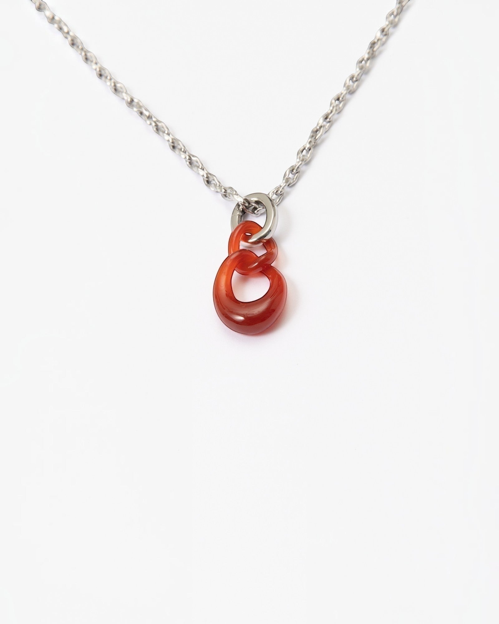 Elsita Jewelry Link Red necklace featuring two hand-carved interlocked red agate stone chain links on a silver chain.