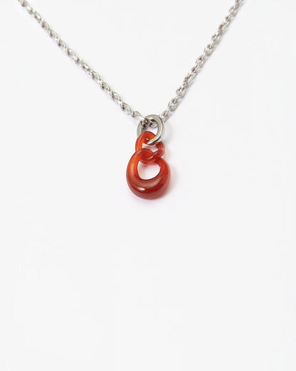 Elsita Jewelry Link Red necklace featuring two hand-carved interlocked red agate stone chain links on a silver chain.