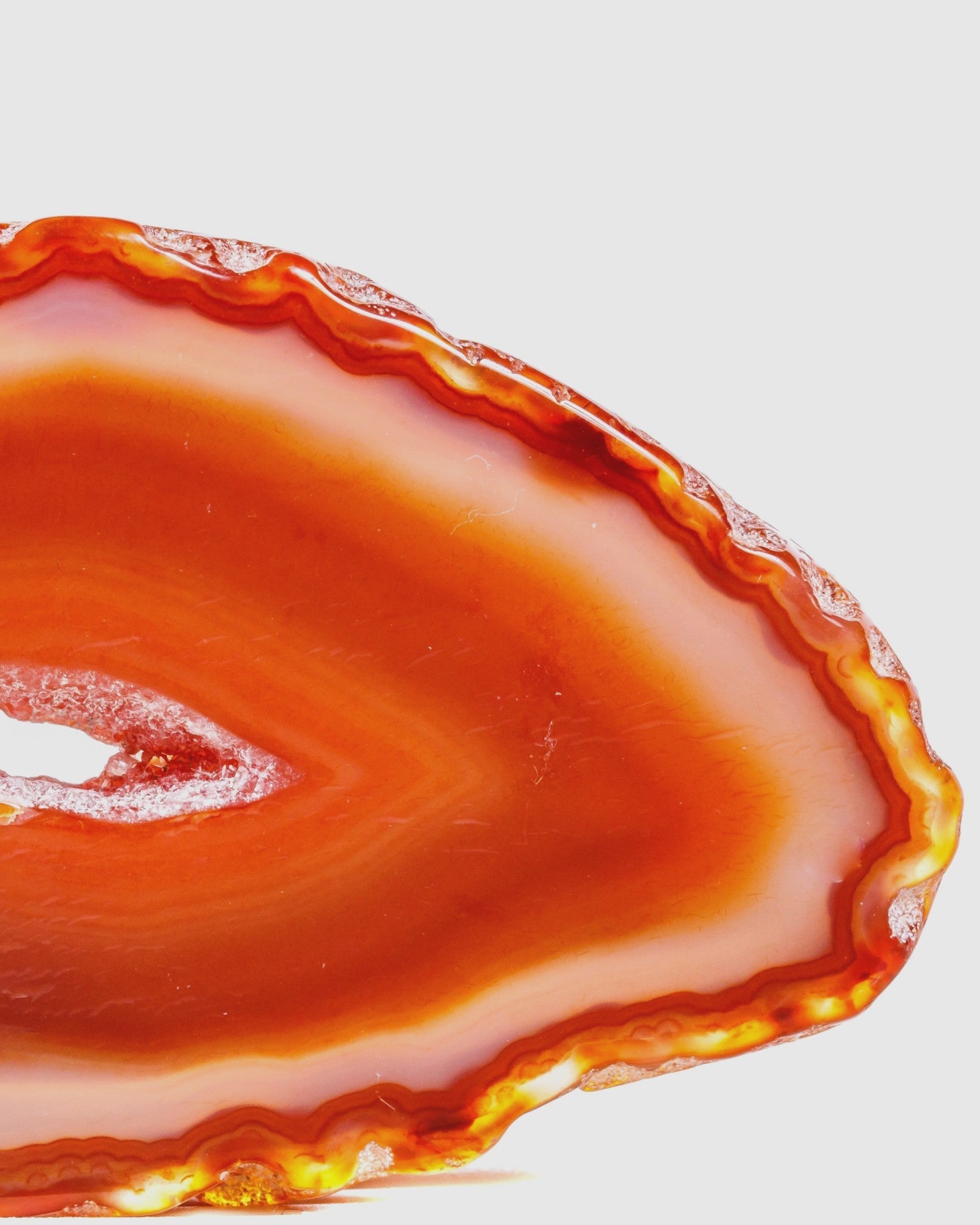 Elsita Jewelry red agate slice with natural orange banding and a central clear quartz crystal formation