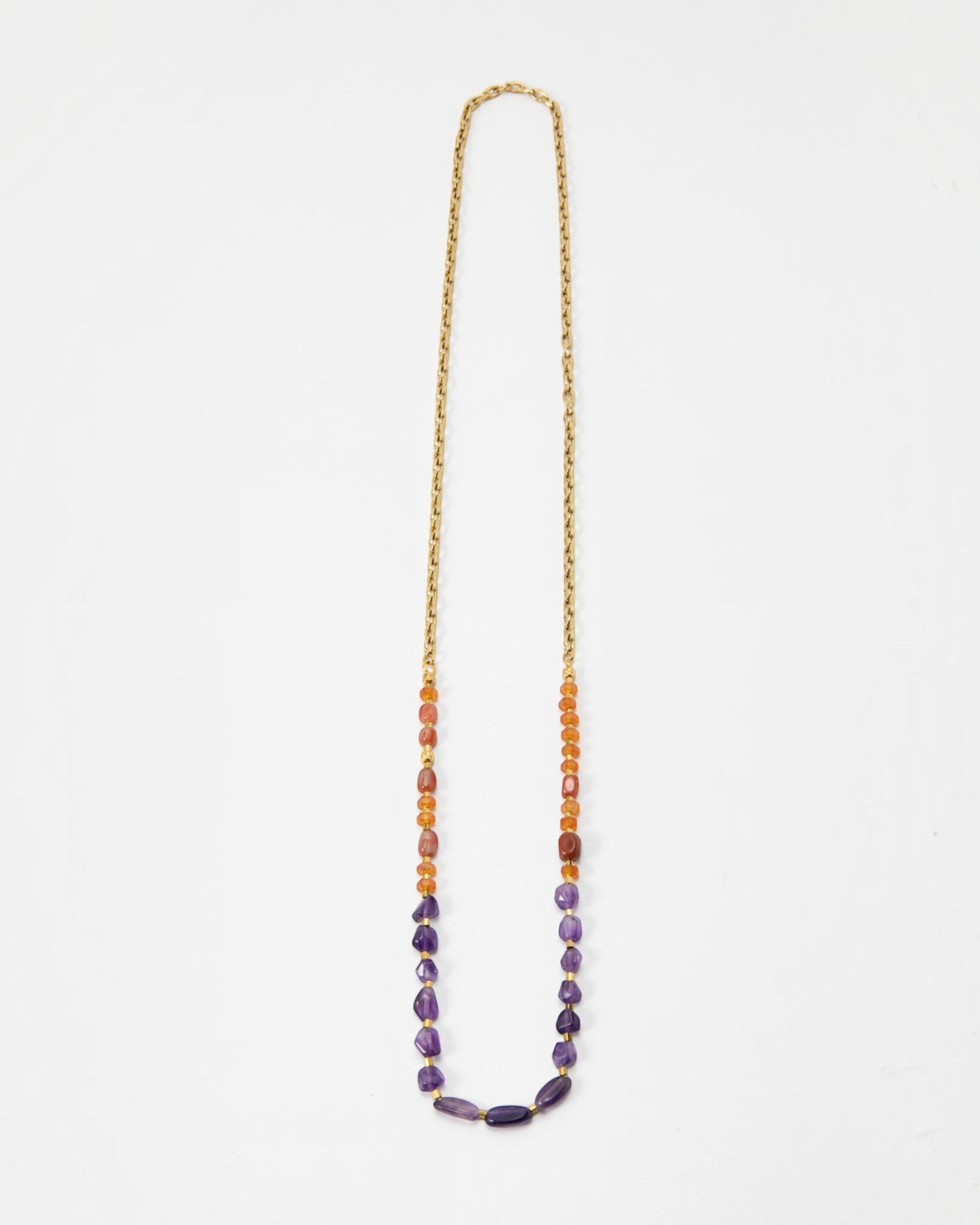 Elsita Jewelry Rhythm long necklace featuring red agate, carnelian, and amethyst beads on a gold stainless steel chain.