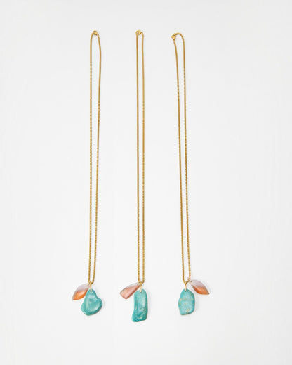 Elsita Jewelry Rusty I necklaces featuring gold chains with dangling turquoise and orange stone pendants