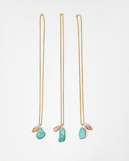 Elsita Jewelry Rusty III gold chain necklaces featuring raw turquoise and translucent peach stone pendants
