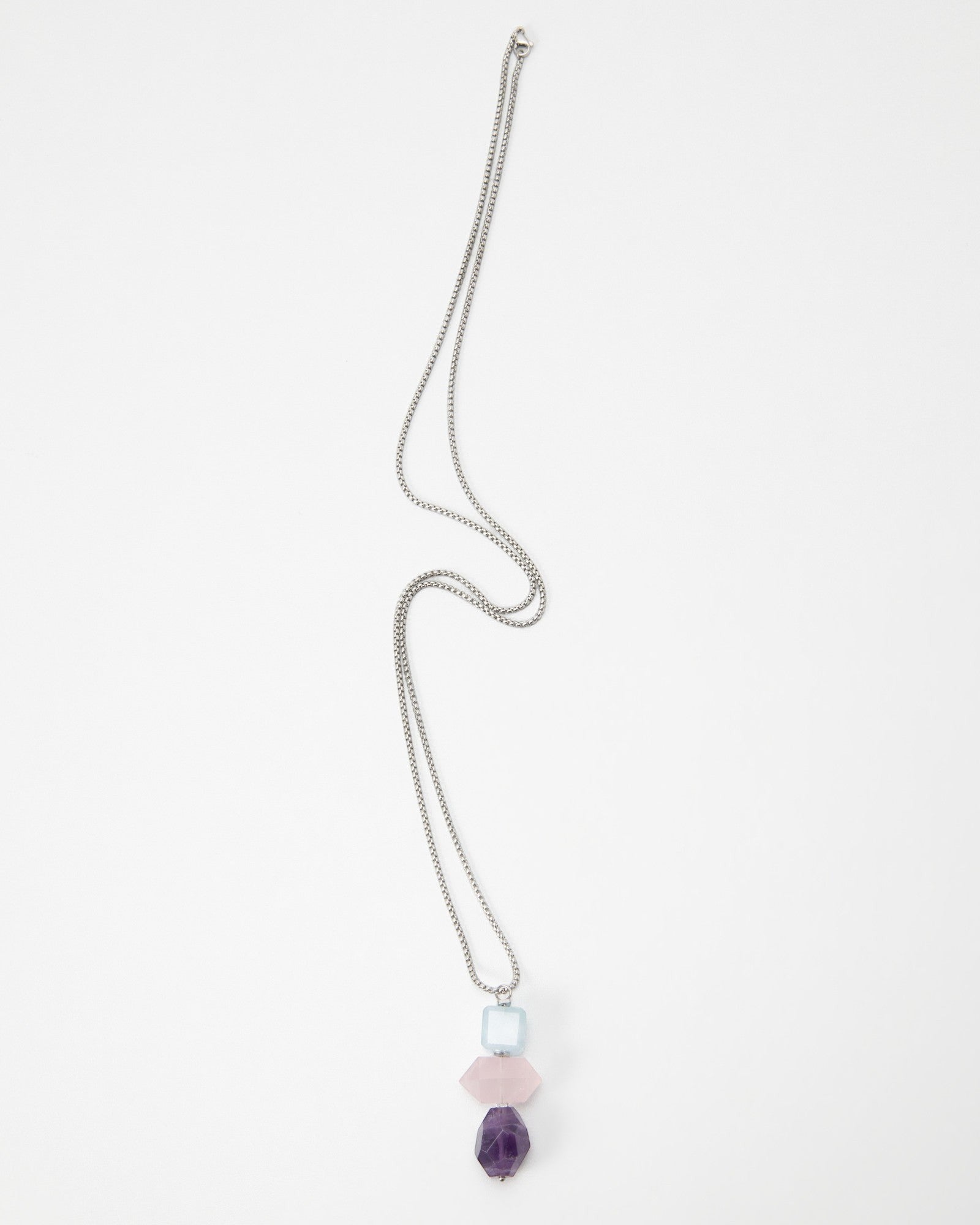 Elsita Jewelry Shape necklace featuring a silver chain with stacked light blue, pink, and purple geometric beads.