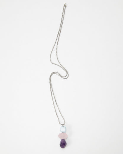 Elsita Jewelry Shape necklace featuring a silver chain with stacked light blue, pink, and purple geometric beads.
