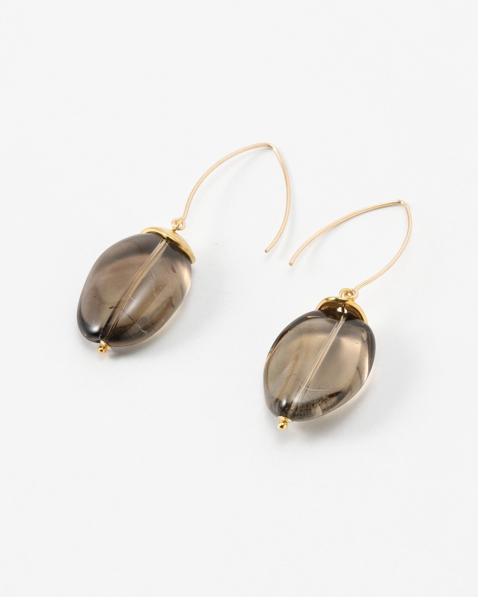 Elsita Jewelry Smoke earrings featuring oval-shaped translucent grey quartz stones on delicate gold wire hooks.