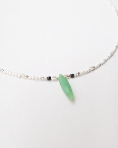 Elsita Jewelry Snowline Green necklace featuring white howlite beads, silver accents, and a green chrysoprase pendant.