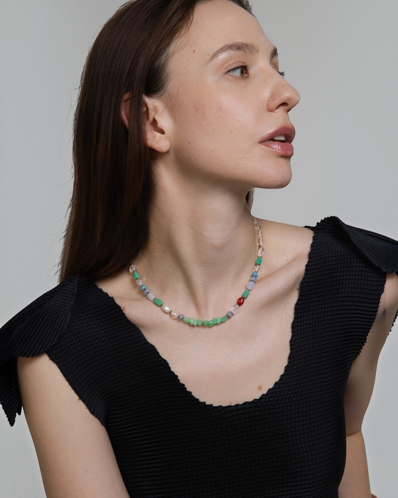 Model wearing Elsita Jewelry Spring necklace featuring multi-colored chrysoprase, pearl, and mineral beads.