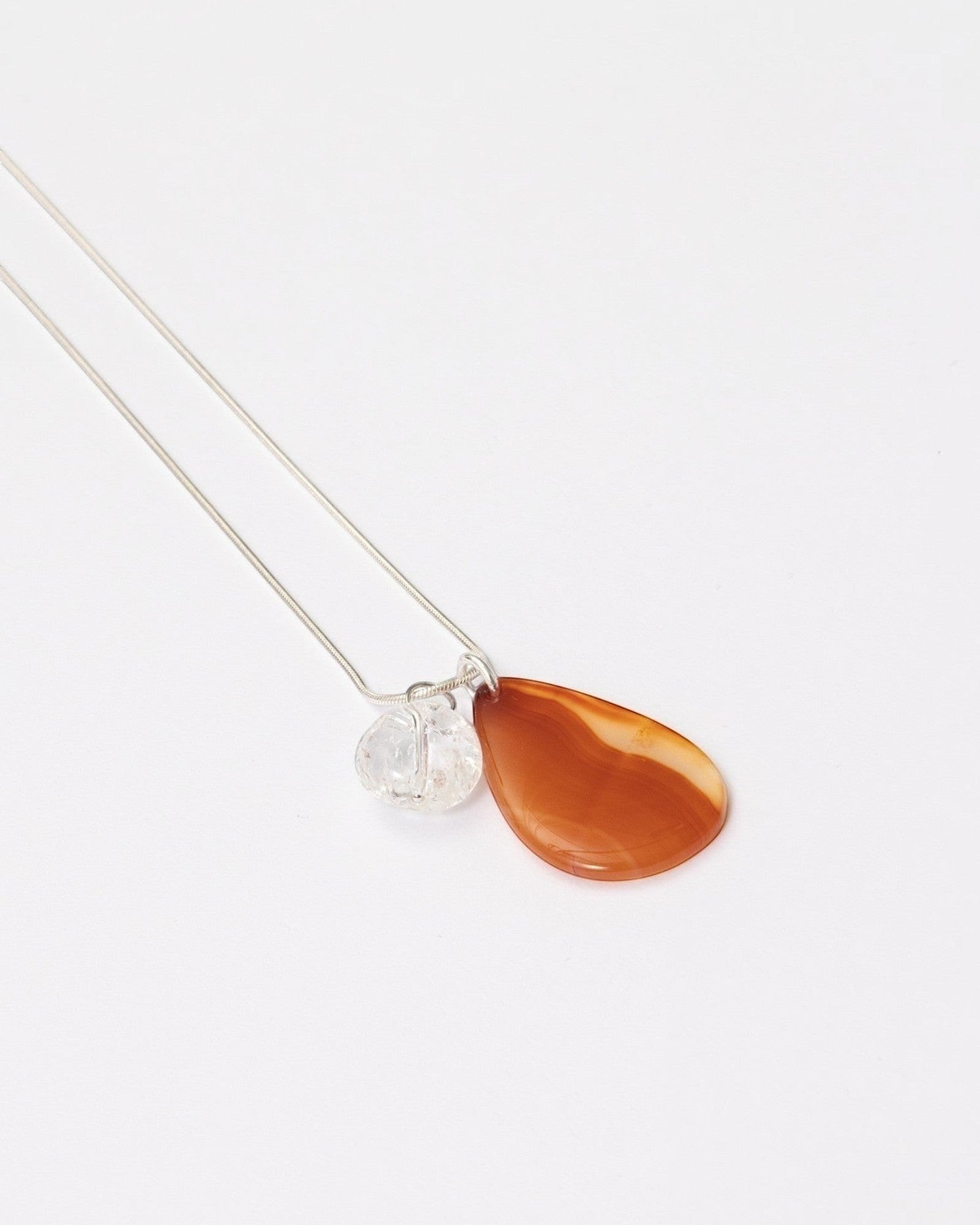 Elsita Jewelry Soda II necklace featuring a teardrop red agate and clear quartz pendant on a sterling silver snake chain