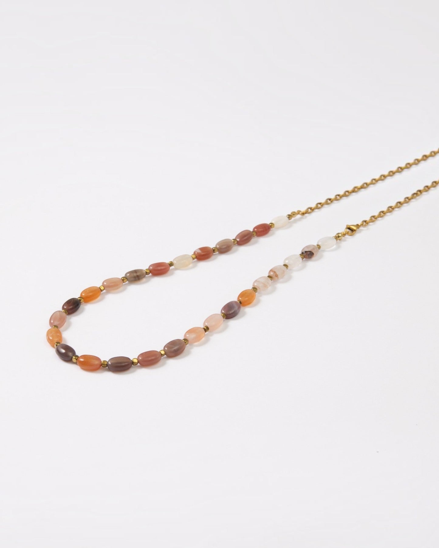 Elsita Jewelry Terrain long necklace featuring oval earth-toned agate stones and a gold-tone stainless steel chain.