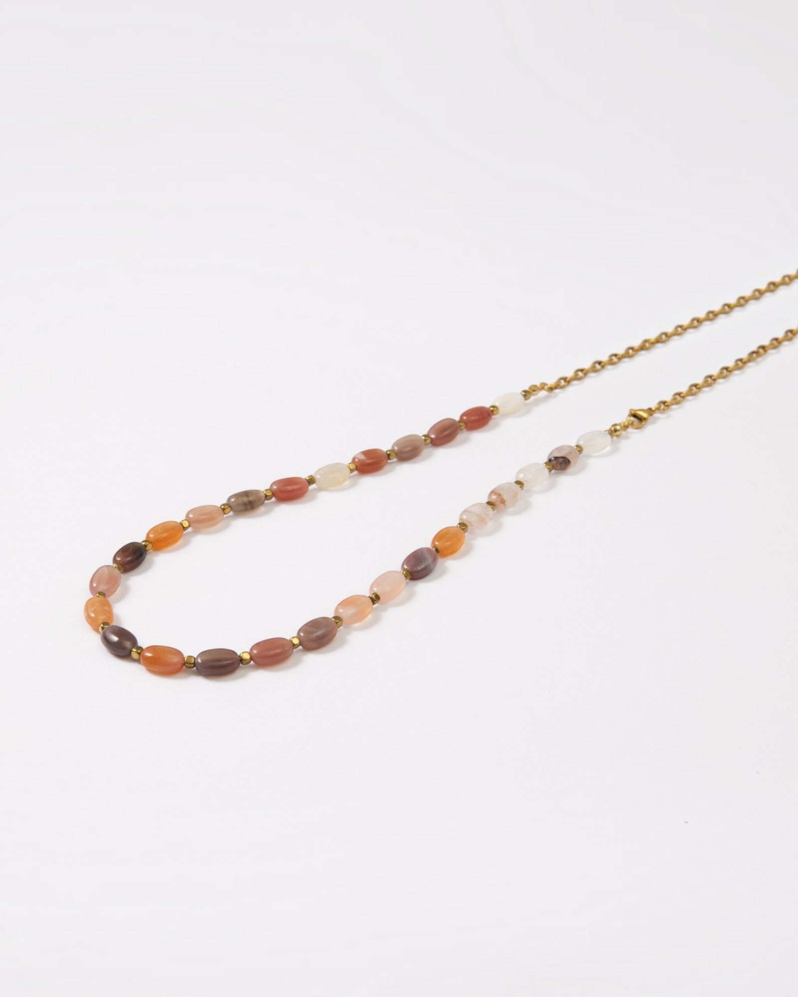 Elsita Jewelry Terrain long necklace featuring oval earth-toned agate stones and a gold-tone stainless steel chain.