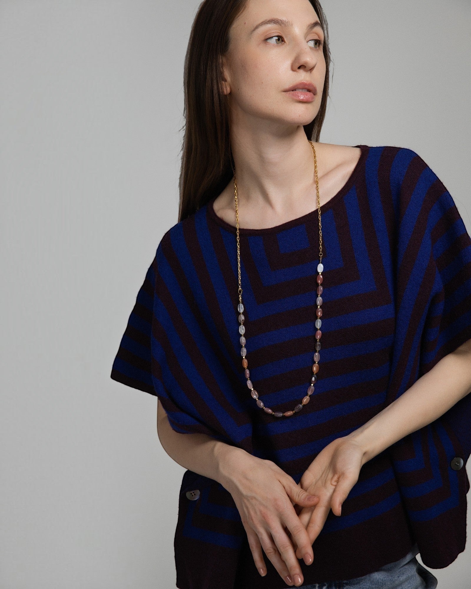 Model wearing Elsita Jewelry Terrain long necklace featuring mixed earth-toned agate beads and a gold-tone chain.