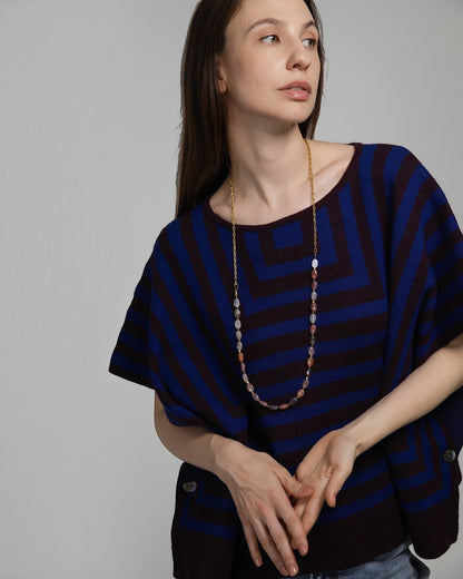Model wearing Elsita Jewelry Terrain long necklace featuring mixed earth-toned agate beads and a gold-tone chain.