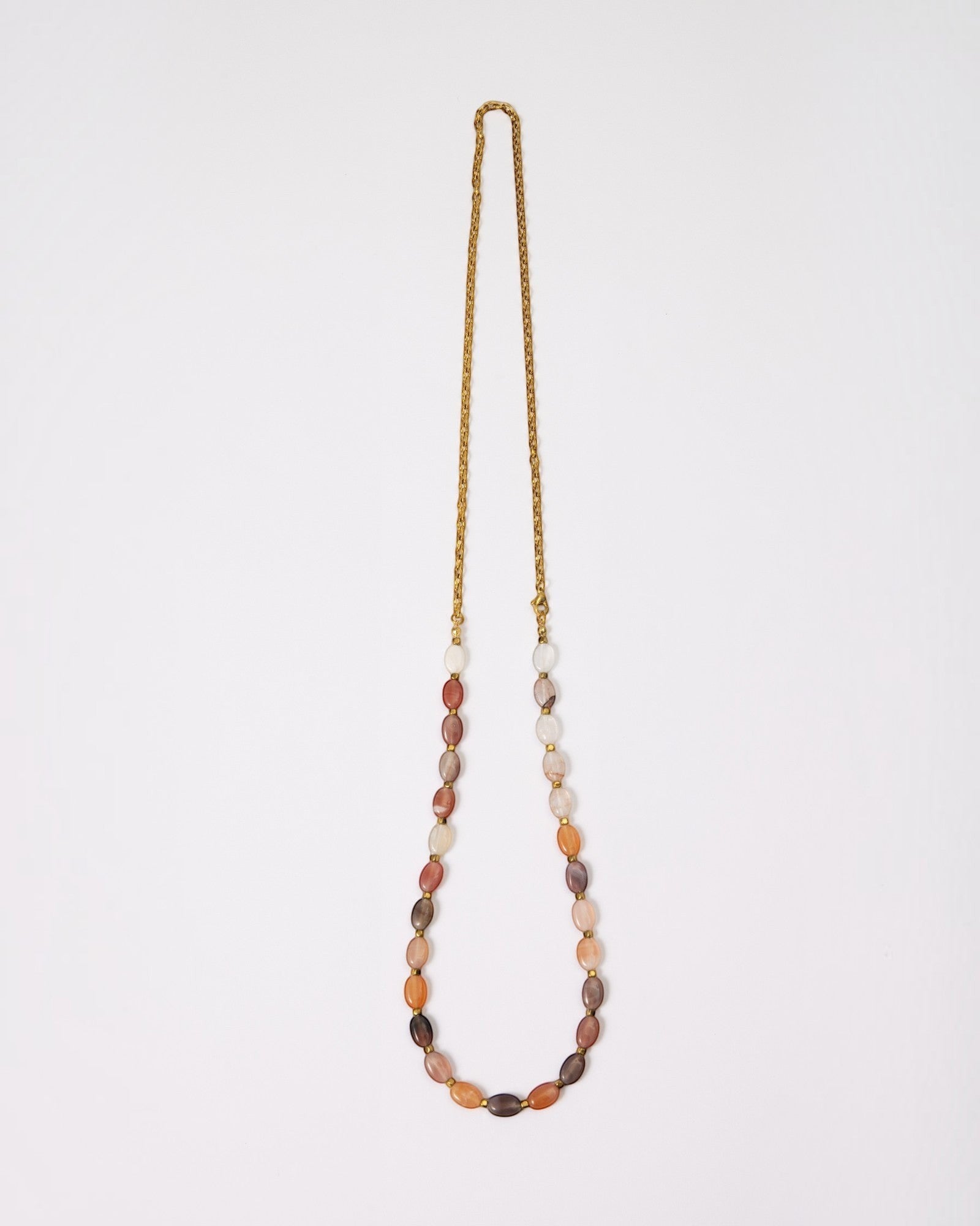 Elsita Jewelry Terrain long necklace featuring oval mixed agate stones in earth tones with a gold-tone chain.