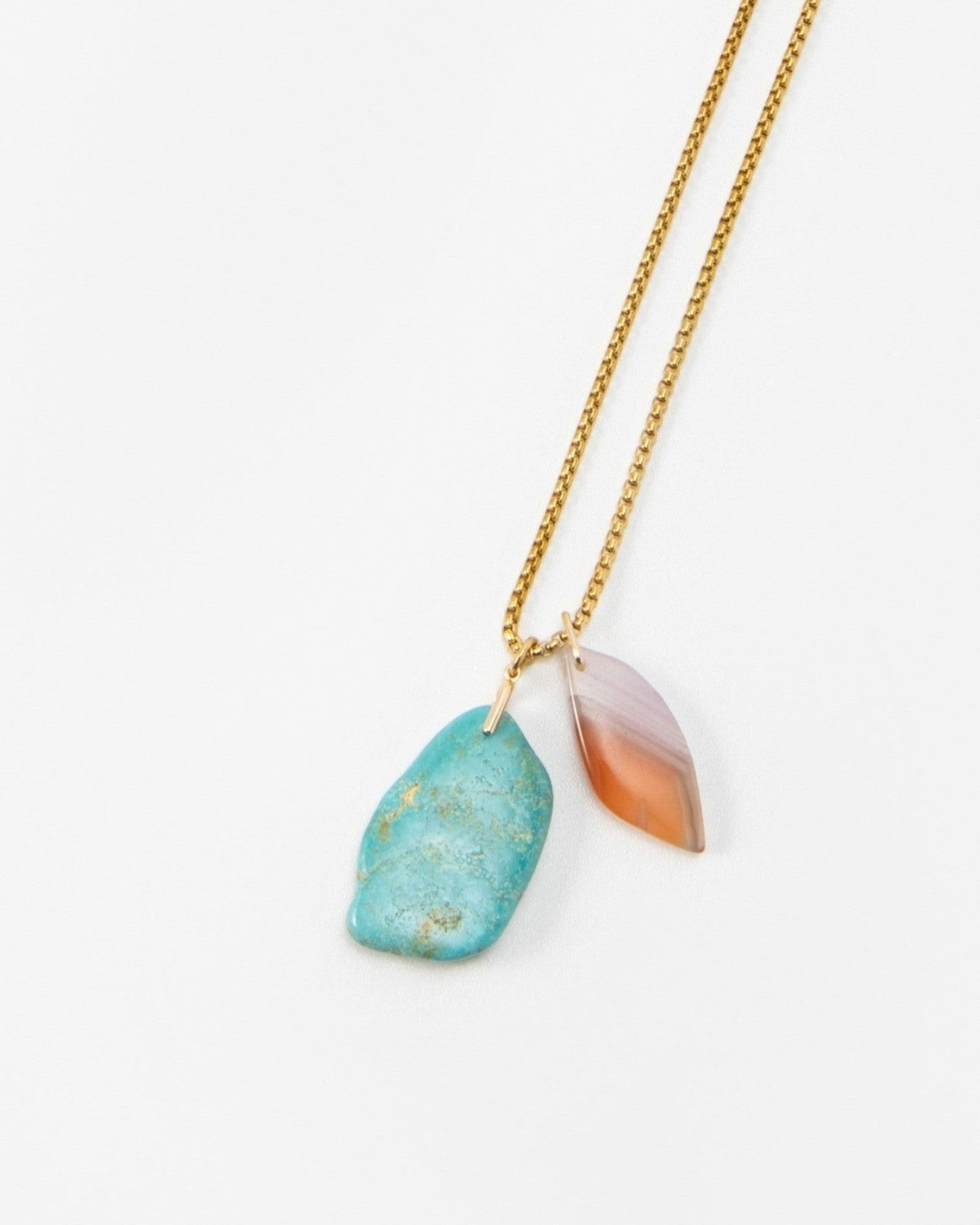 Elsita Jewelry Rusty II necklace featuring a raw turquoise stone and a polished leaf-shaped agate charm on a gold chain