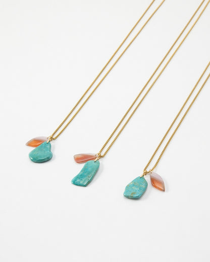 Elsita Jewelry Rusty III gold chain necklaces featuring raw turquoise and teardrop carnelian stone pendants