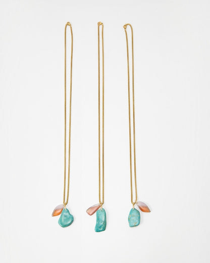 Elsita Jewelry Rusty II gold chain necklaces featuring organic turquoise and translucent peach stone pendants
