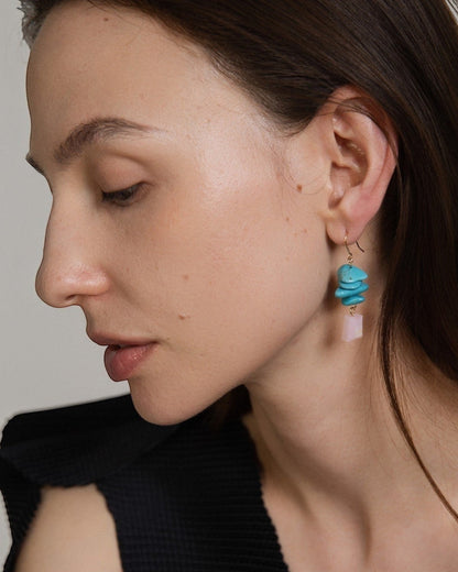 Model wearing Elsita Jewelry Candy earrings featuring layered turquoise slices and a faceted pink opal in 14K gold-filled