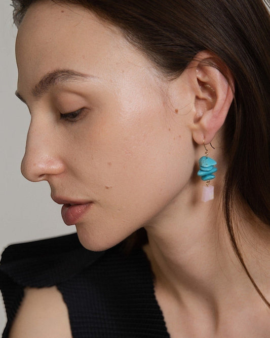 Model wearing Elsita Jewelry Candy earrings featuring layered turquoise slices and a faceted pink opal in 14K gold-filled