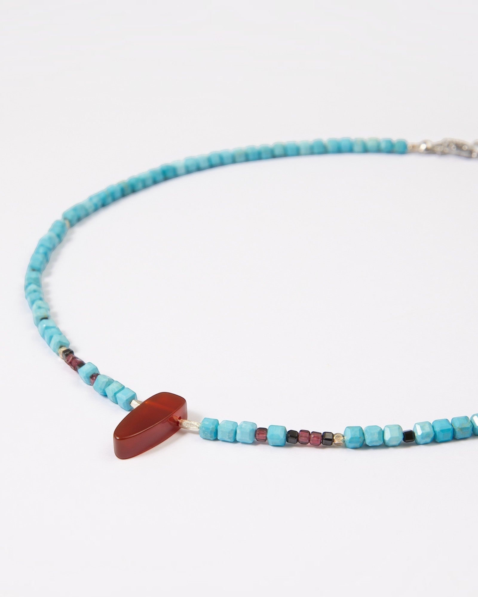 Elsita Jewelry Pixel necklace featuring turquoise cube beads, a red agate pendant, garnet, spinel, and silver accents.