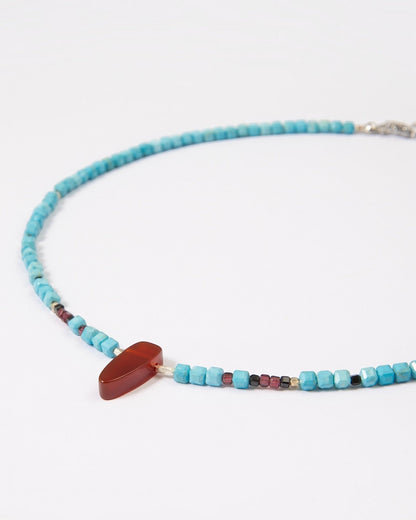 Elsita Jewelry Pixel necklace featuring turquoise cube beads, a red agate pendant, garnet, spinel, and silver accents.