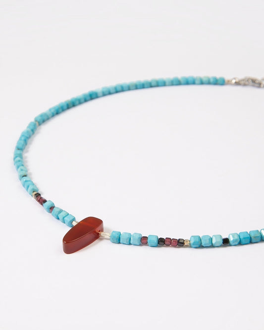 Elsita Jewelry Pixel necklace featuring turquoise cube beads, a red agate pendant, garnet, spinel, and silver accents.
