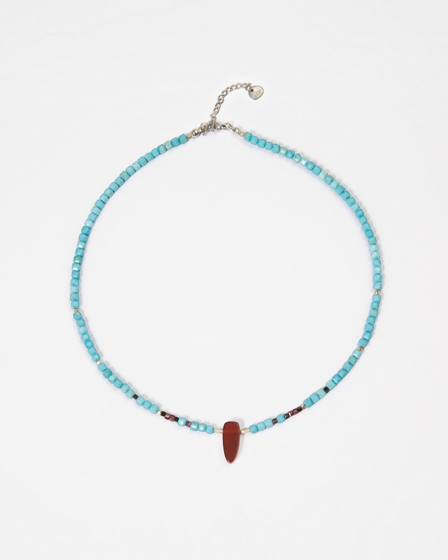 Elsita Jewelry Pixel necklace featuring turquoise cube beads, a red agate pendant, and silver accents on white.