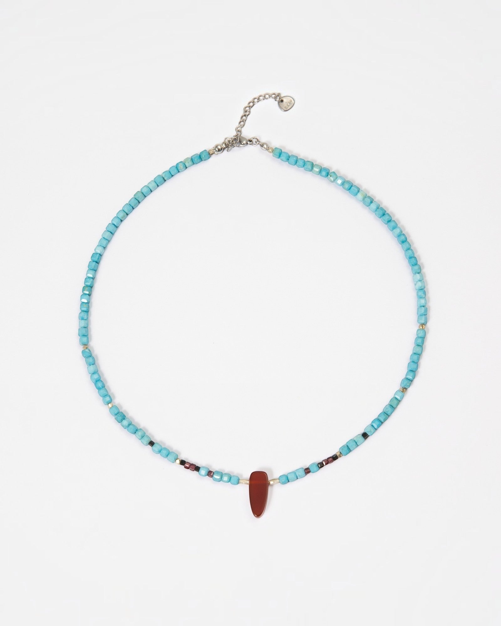Elsita Jewelry Pixel necklace featuring turquoise cube beads, a red agate pendant, and silver accents on white.
