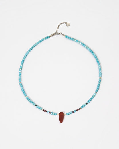 Elsita Jewelry Pixel necklace featuring turquoise cube beads, a red agate pendant, and silver accents on white.