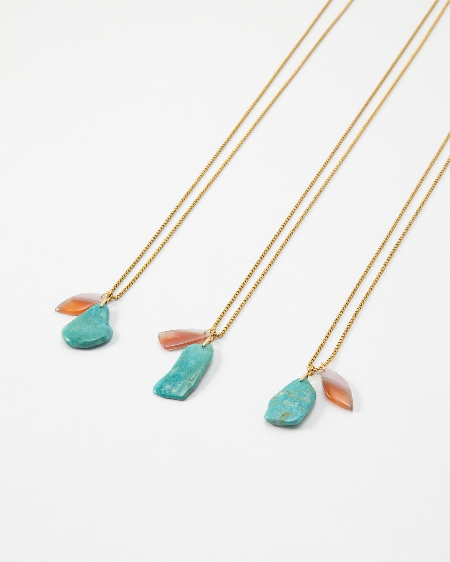 Elsita Jewelry Rusty I necklaces featuring raw turquoise and translucent orange stone pendants on gold chains