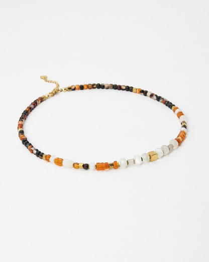Elsita Jewelry Untamed beaded choker necklace with multi-colored gemstones, pearls, and gold-tone accents.