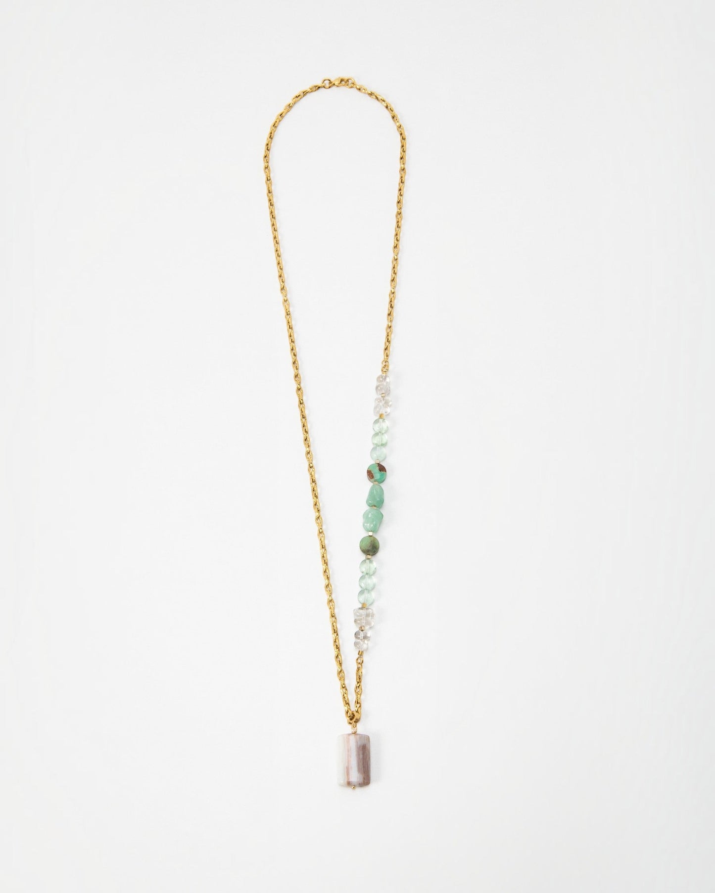 Elsita Jewelry Wandern necklace featuring a gold chain with green and clear gemstone beads and a rectangular pendant