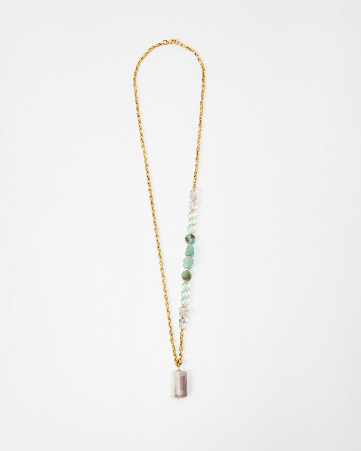 Elsita Jewelry Wandern necklace featuring a gold chain with green and clear gemstone beads and a rectangular pendant
