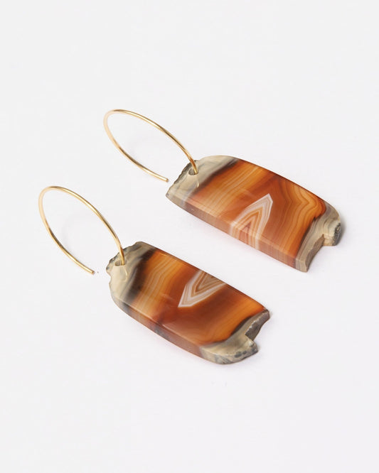 Elsita Jewelry Wild 14 agate earrings featuring raw, freeform orange and brown stone slices on 14K gold-filled hoops.